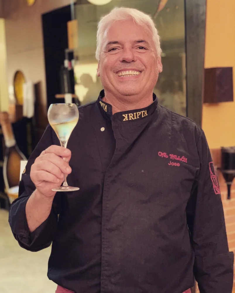 Chef Jose Tallón of Cal Tallón with a glass of sparkling wine