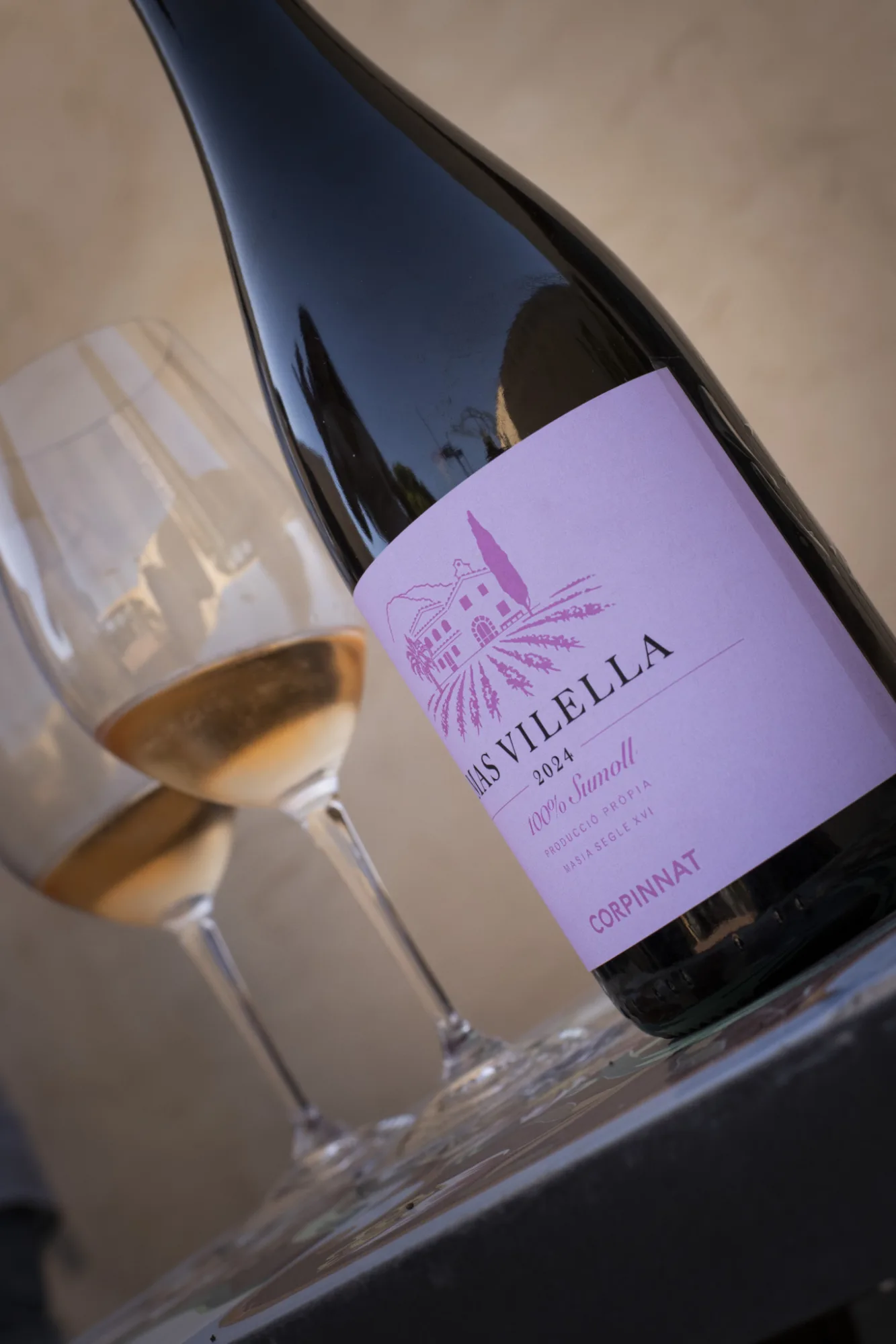 Mas Vilella bottle with glasses of sparkling wine