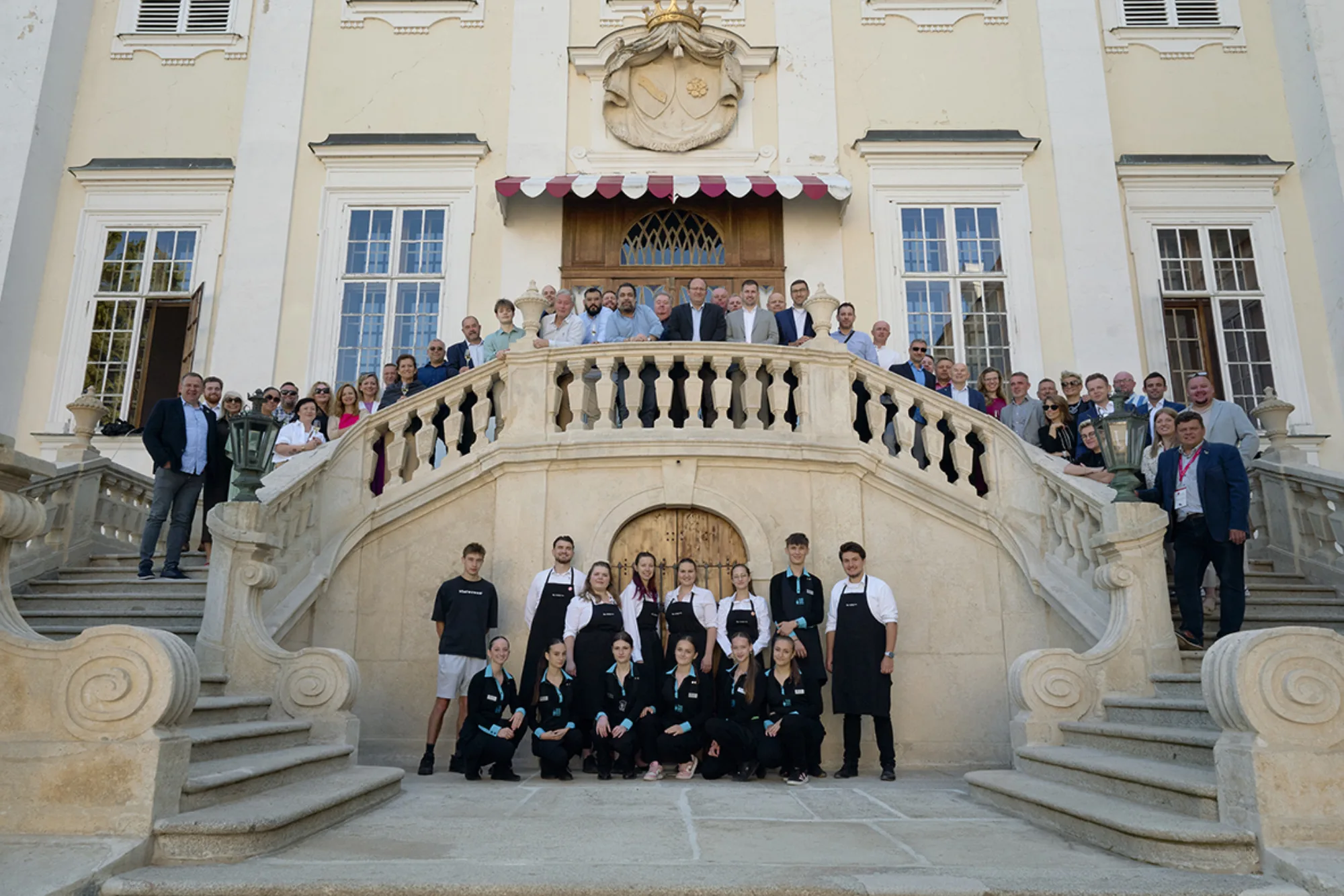 Oenoforum 2025 participants on a palace staircase