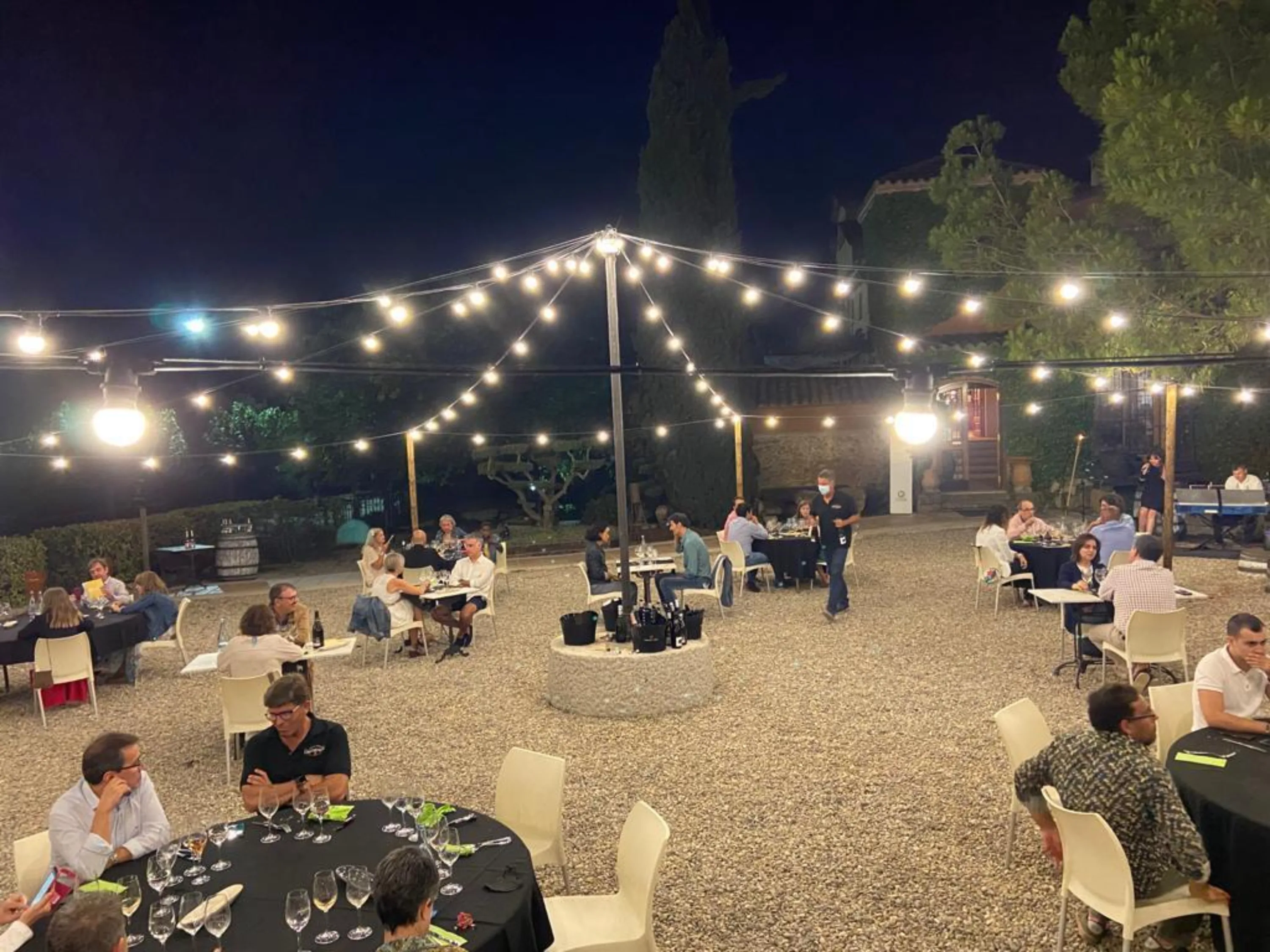 Night-time dinner under string lights at the Corpinnat Gastronomic Festival