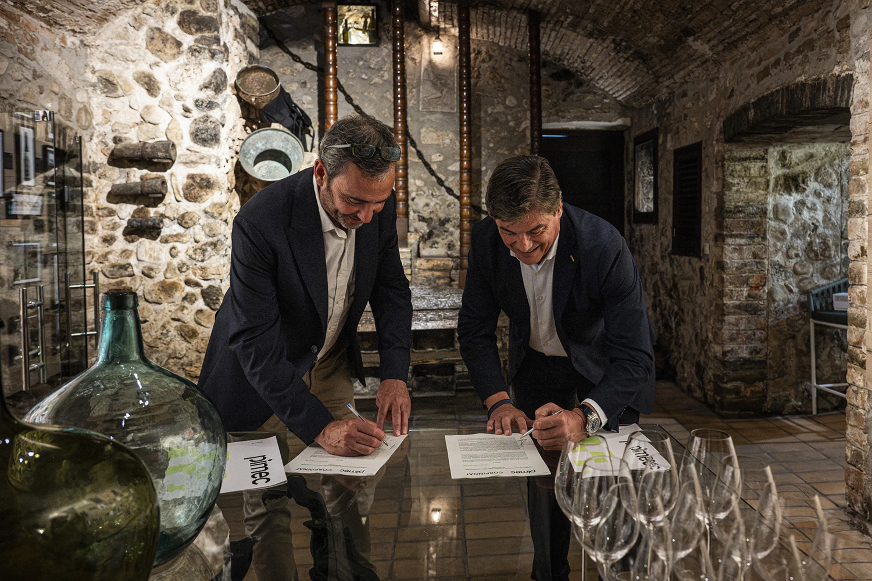 Corpinnat and Pimec signing their agreement in a cellar